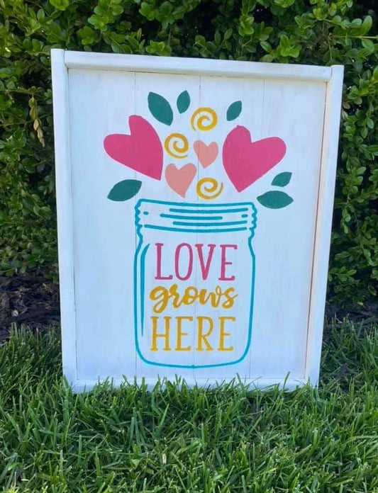 Love grows here with jar and heart flowers